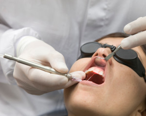 A patient undergoing a dental procedure performed with a laser