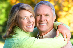 smiling couple with dental implants
