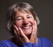 A woman with mini dental implants stabilizing her dentures